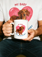man holding a personalized pet portrait mug with a pink heart design, perfect gift for pet lovers.